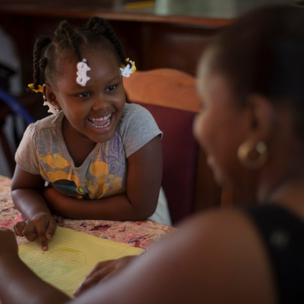 On 20 August 2016 in Belize, 4-year old Zyrah Neal laughs as she and her mother, Sherlette Neal, draw at home at their dining room table, in Belmopan, the capital. Zyrah lives in a middle-class neighbourhood with her mother (who is a government employee), her sister and two brothers. She recently completed preschool and has access to electronics, many toys and books. Ms. Neal, a single-parent, raised six other children before Zyrah was born. She explained the difference she sees in her young daughter’s development as a result of two years of preschool and growing up in a protective and enriching environment: “She’s very advanced, she knows what she wants. I’m raising her in a very different environment to the situations my other children were born into; life was at times chaotic and it had an impact. Zyrah’s a fast learning and loves to get involved in so many activities, it’s hard to keep up sometimes but I manage. My favourite thing to do with her is to go to the park and push her on the swings, and seeing how much she enjoys it.”

In recent years, considerable progress was made in the area of Early Childhood Development. In 2011 only 32 per cent of children between 36 and 59 months of age attended an Early Childhood Education (ECE) programme, but this reached 55 per cent by 2015. Disparities however persist as only one in five of the poorest children attend ECE, and the Cayo district sees the lowest ECE attendance rate (36 per cent).  Further success is contingent upon removing barriers to supply of services, such as sufficient number of qualified professionals and greater integration of the different ECD components. The recent adoption of a national ECD policy demonstrates the Government’s commitment to strengthening ECD services. 

UNICEF and the World Health Organization (WHO), with their national, regional and country partners, promote the use of a range of effective interventions (e.g. Care for Child Development) to help children survive, t
